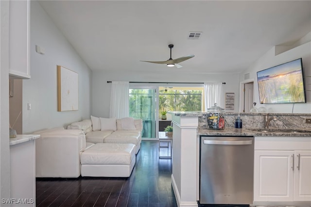 kitchen featuring dishwasher, lofted ceiling, white cabinets, sink, and ceiling fan