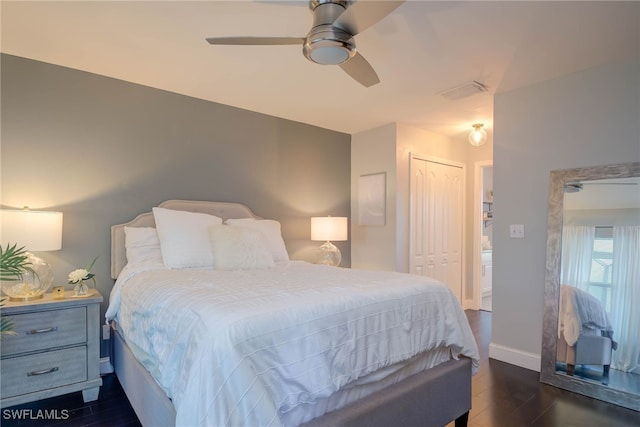 bedroom with ceiling fan, dark wood-type flooring, and a closet