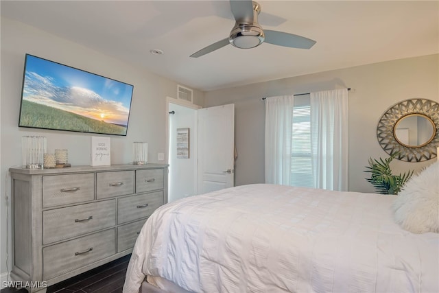 bedroom with ceiling fan and dark wood-type flooring