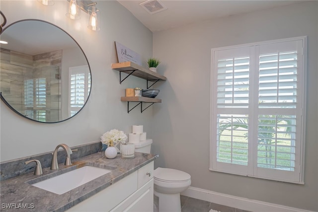 bathroom with vanity, toilet, and a shower with shower door