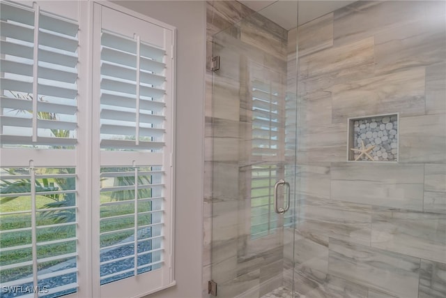 bathroom with a shower with door