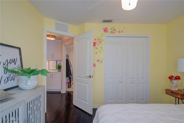 bedroom featuring dark hardwood / wood-style flooring and a closet