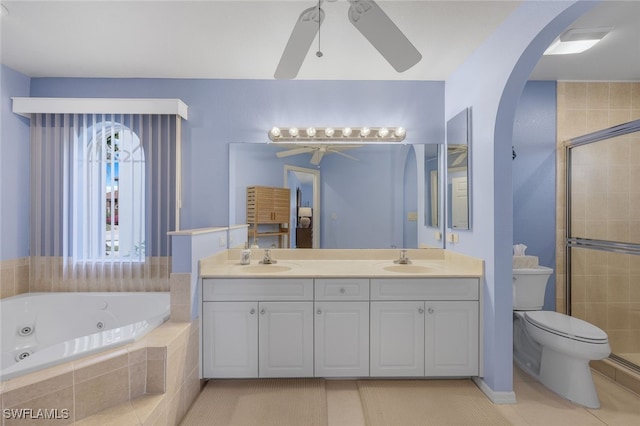 full bathroom with ceiling fan, toilet, vanity, and separate shower and tub