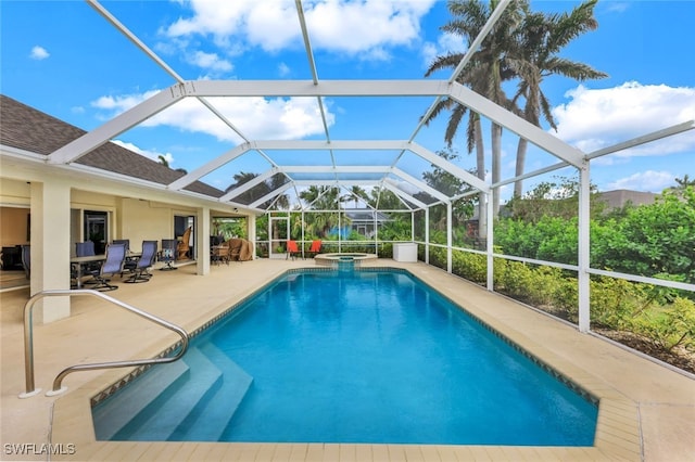 view of pool featuring a lanai, an in ground hot tub, and a patio