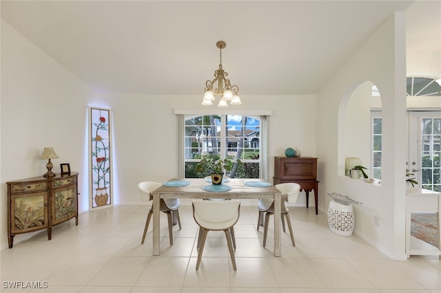 dining room with light tile patterned floors and a chandelier