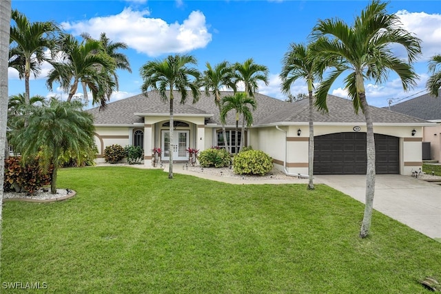 ranch-style house with a front lawn, a garage, and french doors