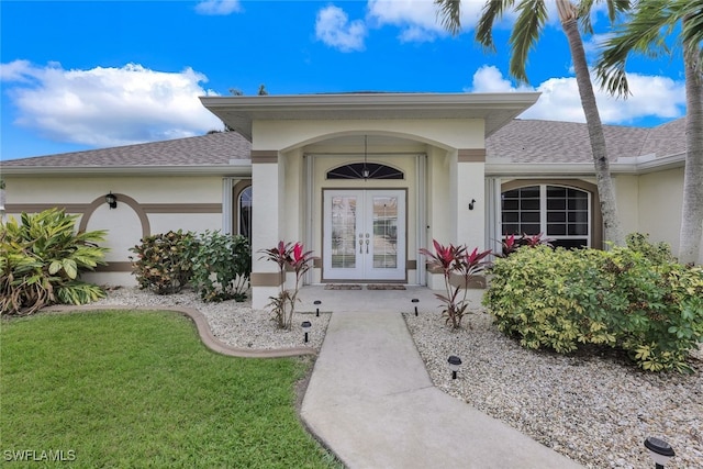 doorway to property featuring french doors and a yard