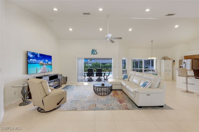 tiled living room with ceiling fan and lofted ceiling