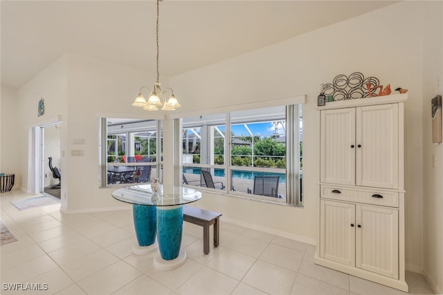 tiled dining space featuring vaulted ceiling and an inviting chandelier