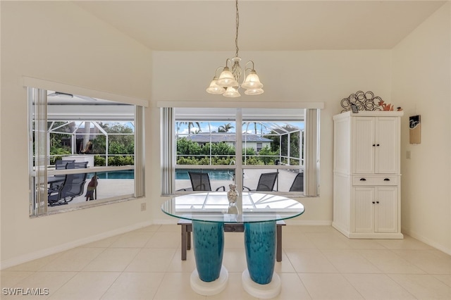 dining area with light tile patterned floors and an inviting chandelier