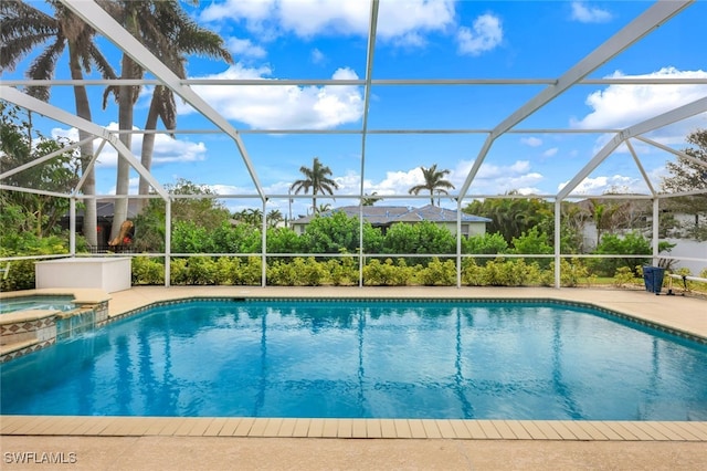 view of swimming pool with a lanai, a patio area, and an in ground hot tub