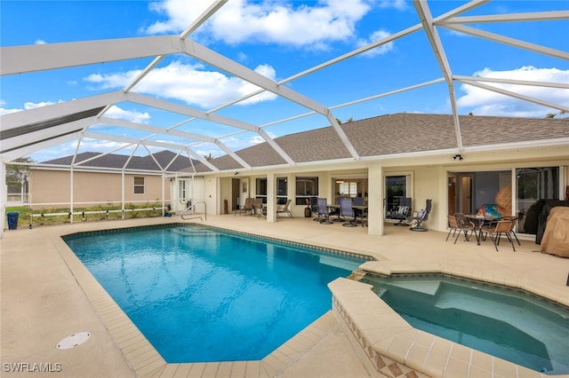 view of pool featuring an in ground hot tub, a lanai, and a patio area