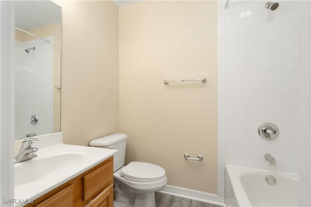 full bathroom with vanity, toilet, wood-type flooring, and tiled shower / bath combo