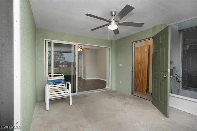 interior space with ceiling fan