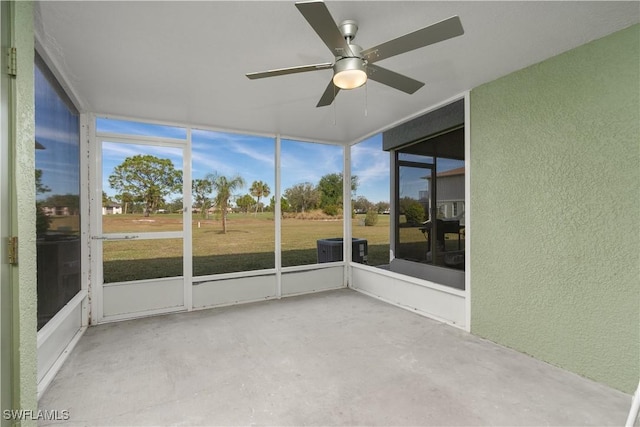 unfurnished sunroom featuring ceiling fan