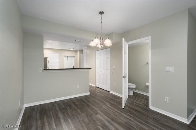 interior space featuring a chandelier and dark wood-type flooring