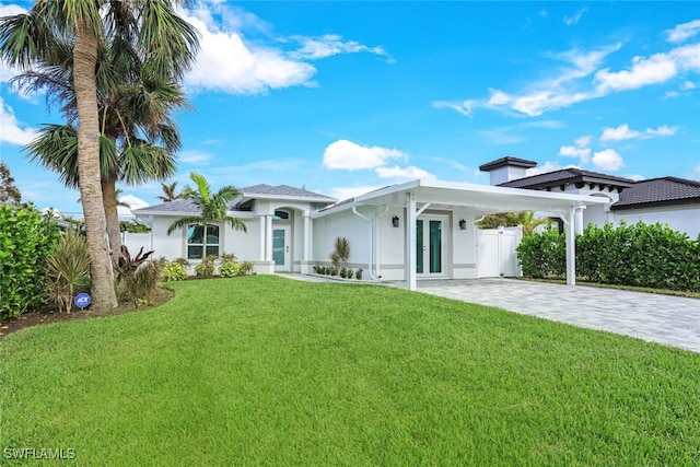 view of front facade featuring a front lawn and french doors