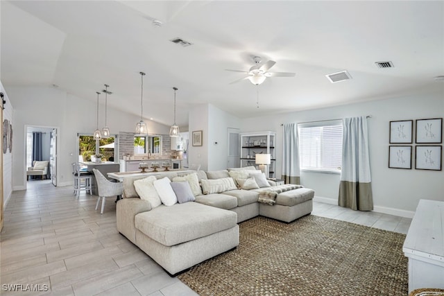 living room with ceiling fan and lofted ceiling