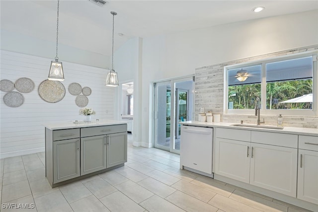 kitchen featuring dishwasher, light tile patterned floors, pendant lighting, and sink