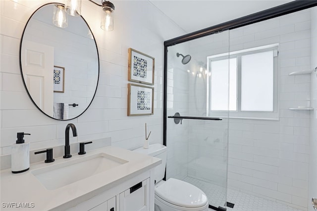 bathroom with vanity, toilet, and an enclosed shower