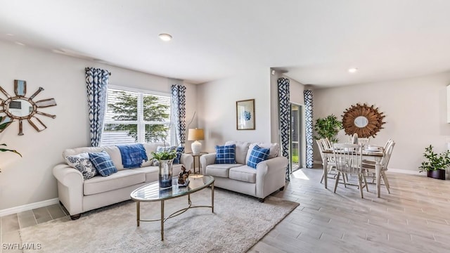 living area with wood tiled floor, baseboards, and recessed lighting