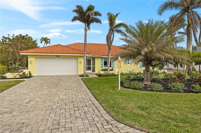 view of front of property with a garage and a front lawn