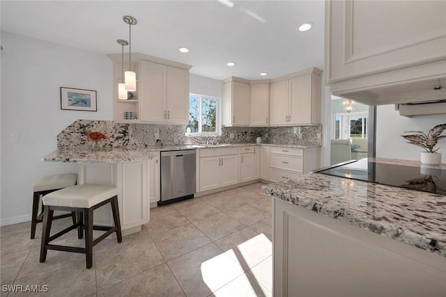 kitchen with pendant lighting, dishwasher, a healthy amount of sunlight, and backsplash