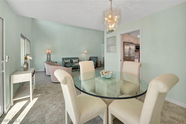 dining area featuring a notable chandelier