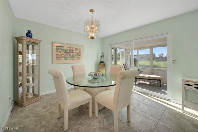 dining room featuring light tile patterned floors and a notable chandelier