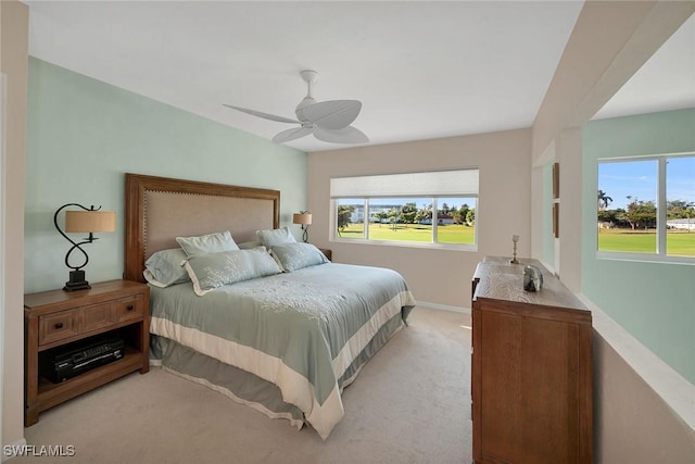 bedroom with ceiling fan and light colored carpet