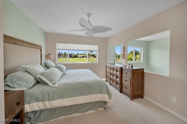 bedroom with ceiling fan and light carpet