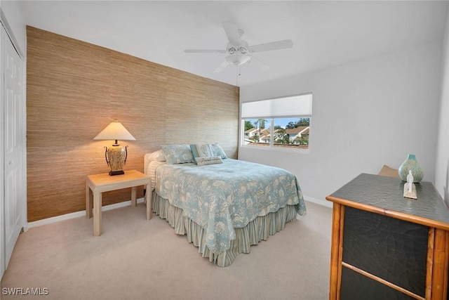 carpeted bedroom featuring ceiling fan and a closet