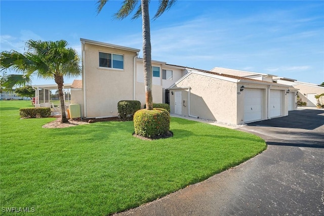 view of property exterior featuring a lawn and a garage