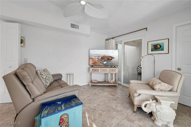 living room featuring tile patterned flooring, visible vents, and a ceiling fan