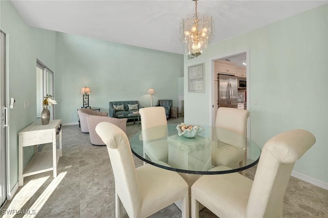 dining room featuring baseboards and an inviting chandelier