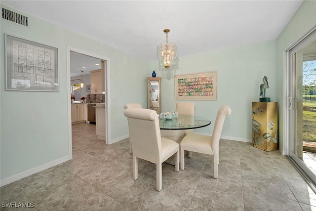 dining room with a chandelier, light tile patterned floors, visible vents, and baseboards