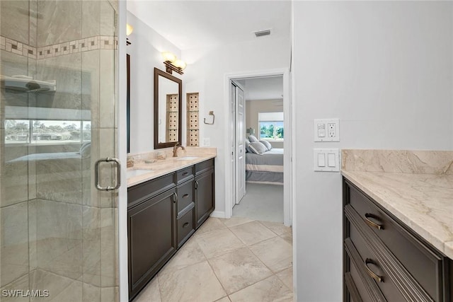 bathroom featuring visible vents, connected bathroom, a shower stall, and vanity