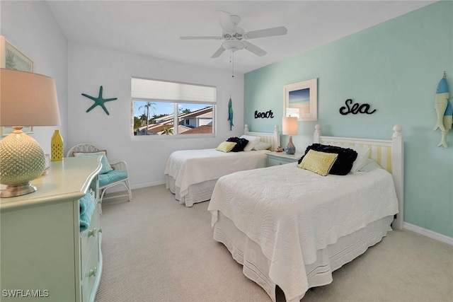 bedroom with baseboards, a ceiling fan, and light colored carpet