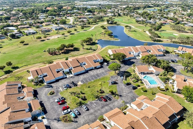 aerial view with a residential view, view of golf course, and a water view