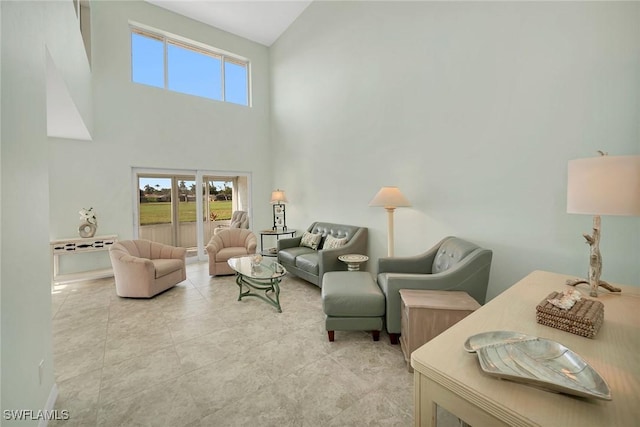 living area featuring light tile patterned floors and a high ceiling