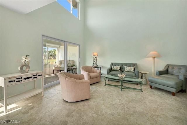 living room featuring a towering ceiling and tile patterned floors