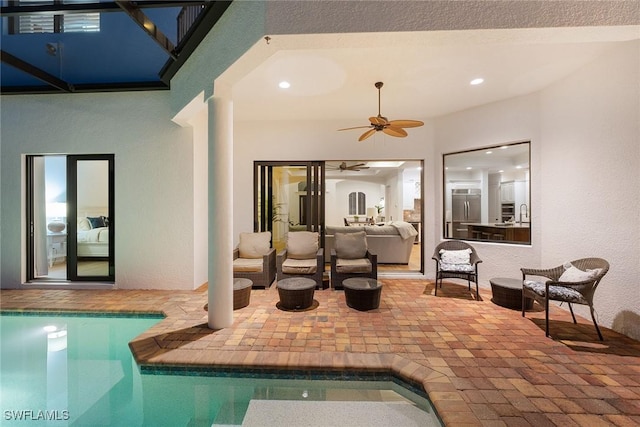 view of patio with ceiling fan, an indoor pool, and an outdoor living space