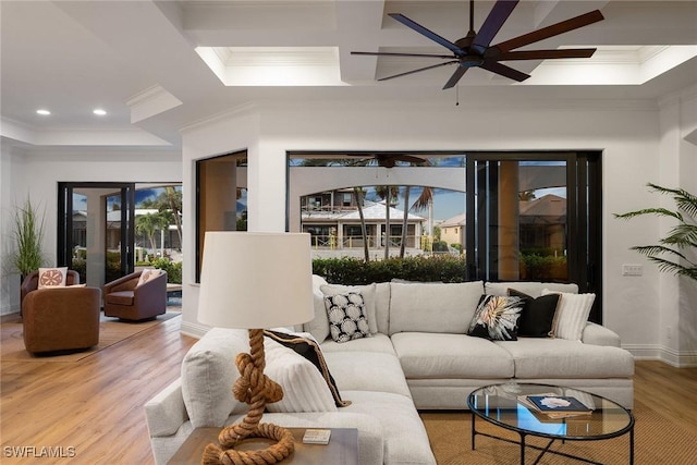 living room with ceiling fan, a healthy amount of sunlight, light hardwood / wood-style floors, and ornamental molding