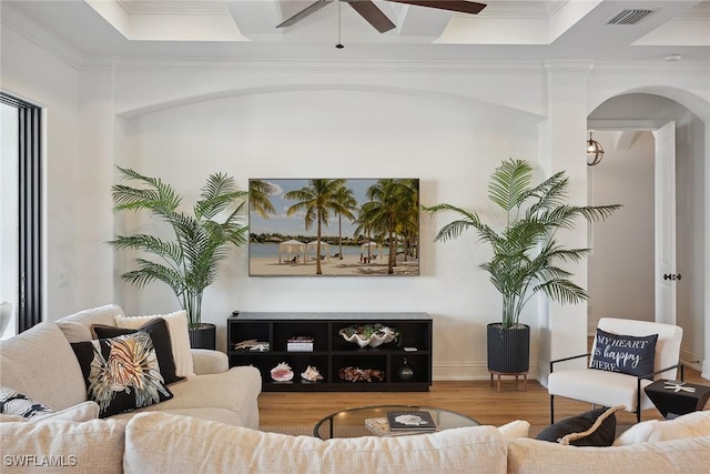 living room with ceiling fan, wood-type flooring, and crown molding