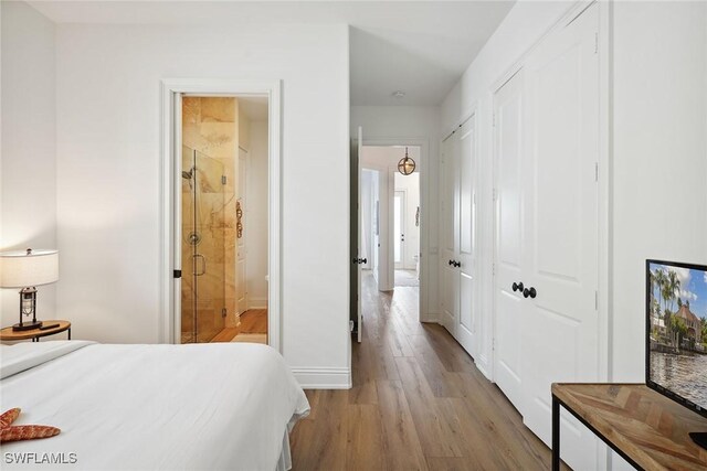 bedroom with ensuite bathroom and light wood-type flooring