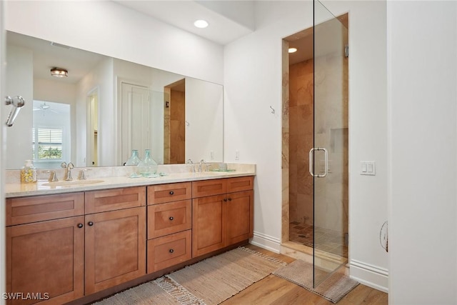 bathroom featuring an enclosed shower, vanity, hardwood / wood-style flooring, and ceiling fan