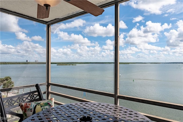 interior space featuring a water view and a balcony