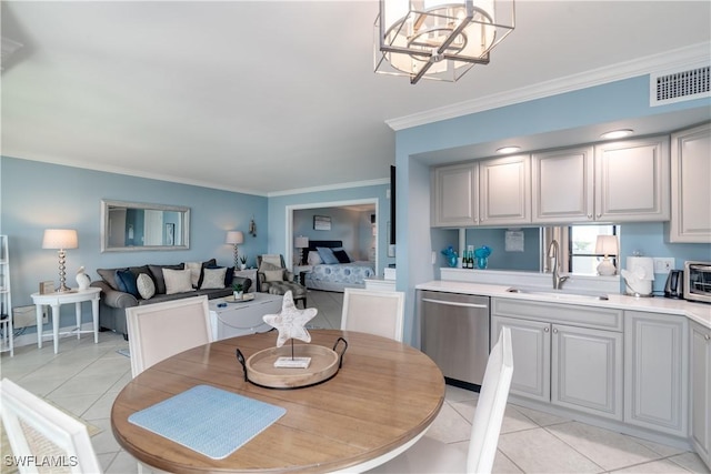 tiled dining space with a notable chandelier, ornamental molding, and sink