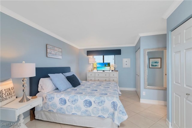 bedroom with light tile patterned floors, a closet, and crown molding