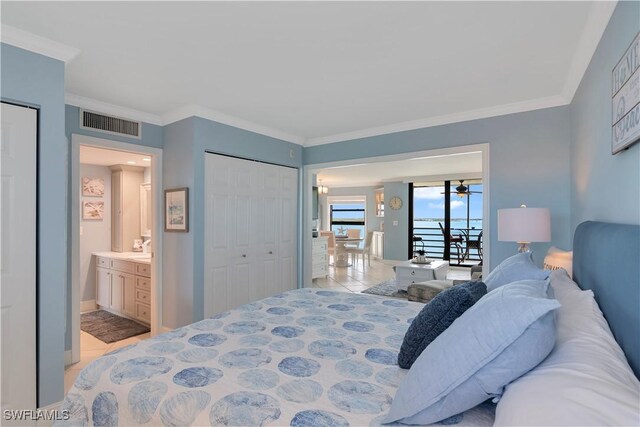 bedroom with access to exterior, light tile patterned floors, ensuite bath, and ornamental molding